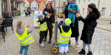 Kita-Kinder haben in der Innenstadt von Spremberg bunte Eier aus Kunststoff an kleinen Birken aufgehängt. Mit großer Begeisterung halfen unter anderem die Mädchen und Jungen aus der Kita Graustein dabei, das Stadtzentrum zu schmücken. (Bild: ASG Spremberg GmbH/Tobias Roitsch)