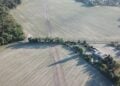 Luftbild: Die auf dem Feld markierte Trassenführung der geplanten Ortsumfahrung verläuft nahe an der Wohnbebauung