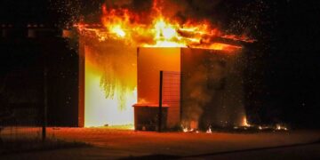 Ein Carport steht in der Nacht in Vollbrand, Funken fliegen