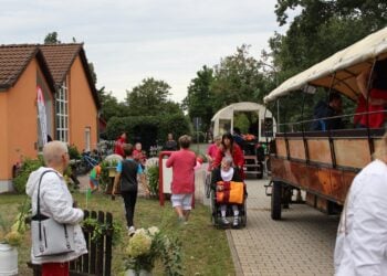 Bewohner der DRK-Wohnstätte Waldblick gehen zu den wartenden Kremserwagen