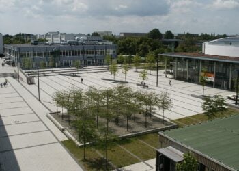 Blick von oben auf den gepflasterten zentralen Platz des BTU-Campus mit Baumreihen und Gebäuden