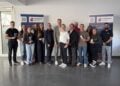Gruppenfoto von 15 Personen in einem hellen Raum vor zwei Aufstellern des Rettungsdienstes Spree-Neiße