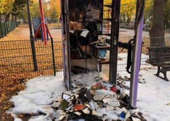 Die ausgebrannte Bücherzelle am Spielplatz in Alt Großziethen mit verkohlten Büchern davor