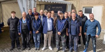Gruppenfoto von rund 20 Mitarbeitenden der BBF Elektrotechnik vor einem Zelt mit der Aufschrift BBF Gruppe