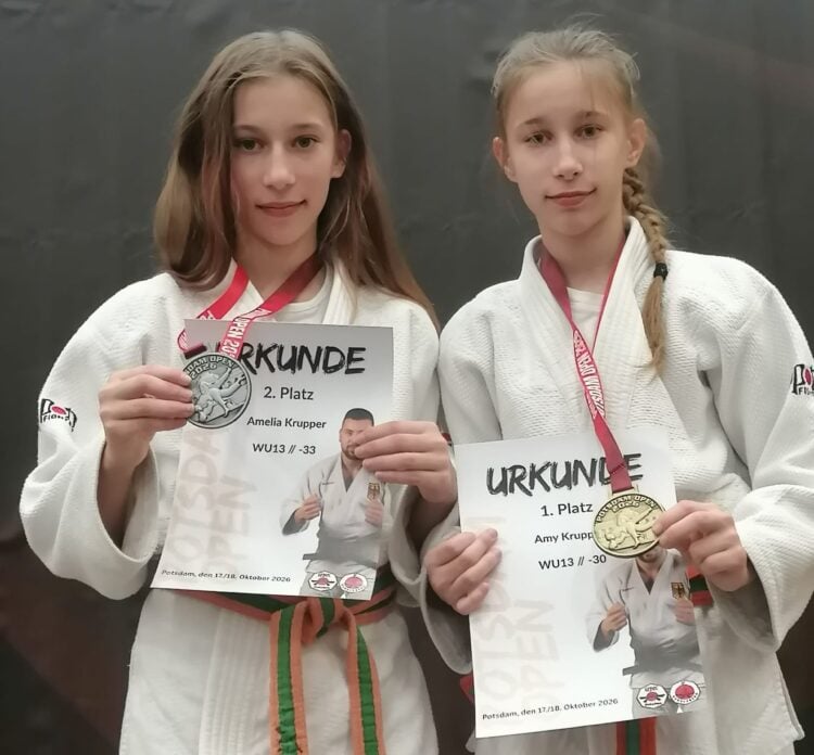 Die Judoka Amelia und Amy Krupper vom KSC ASAHI Spremberg zeigen ihre Silber- und Goldmedaille mit Urkunden der Potsdam Open 2026