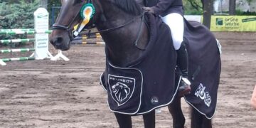 Reiterin des Reitvereins Sielow mit Siegerschleife und Abschwitzdecke